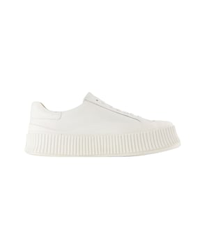 Introducing Jil Sander shoes, where minimalist design meets exquisite craftsmanship. These footwear pieces seamlessly blend timeless aesthetics with exceptional attention to detail, offering versatile options to elevate your footwear collection. To enhance your look with Jil Sander shoes, envision them as the essential element of a refined and sophisticated ensemble. Pair them with tailored trousers, a well-fitted blouse, and delicate jewelry for a polished and elegant appearance suitable for both professional settings and elegant evenings. Jil Sander's shoes reflect the brand's dedication to quality and fashion, providing you with timeless yet contemporary choices that effortlessly combine classic allure with modern sophistication. Step out with confidence, showcasing your distinctive fashion sensibility and the shoes' understated beauty. Colours: BEIGE - NEVE. Main material: smooth calfskin. Sole: rubber. Lining material: leather. Closure: top laces. Toe shape: round. Fit: true to size - Sizing: