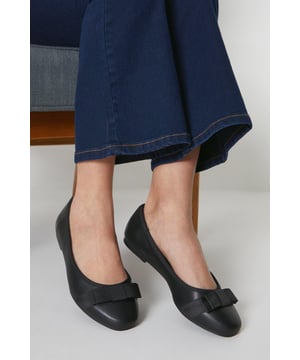 Chic faux leather ballet pumps with a wide fit for added comfort
Elegant bow detail adorns the toe for a feminine touch
Slip-on style for easy on and off
Flat sole provides all-day wearability
faux leather upper with a synthetic lining

These versatile ballet pumps from Dorothy Perkins exude effortless sophistication. The wide fit ensures a comfortable wear, while the bow detail adds a touch of elegance. Pair them with tailored trousers for a polished workwear ensemble or team with a floral dress for a charming daytime look. Perfect for casual events, family gatherings, or meeting friends for brunch, these flats strike the perfect balance between style and comfort.