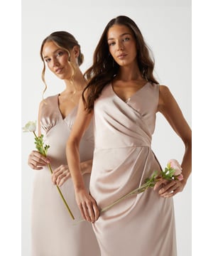 Imagined in a classic wrap silhouette and accentuated by draped details, this bra-friendly maxi dress will elevate any bridal party. Made from Katy satin: exuding a lustrous sheen, this satin fabric displays a textured appearance, adding extra character to every piece. A sturdy complexion helps hold the shape of the design for a curated silhouette whatever the style. Level of stretch: little. This dress fastens with a rear concealed zip. Perfect for a town hall wedding. ?
