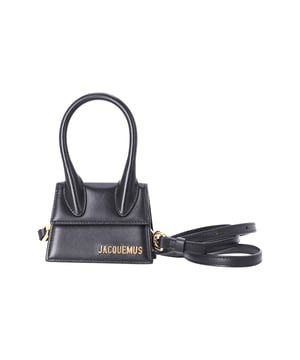 VINTAGE, RRP AS NEW
This mini top-handle bag boasts a structured silhouette. The bag is finished with the brand's signature logo lettering, giving it an elegant touch. With a removable crossbody strap for versatility and a magnetic closure for security, this Jacquemus Le Chiquito Top Handle Bag is the perfect accessory to elevate your look.

Jacquemus Le Chiquito Top Handle Bag in Black Leather	
Condition: excellent
Material: Leather
Size: one size
Width:   5mm
Length:   11mm
Height:   9mm
Sign of wear: no
SKU: 363292