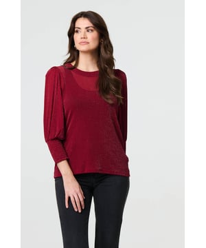 Dress for a smart-casual occasion with this glittery top. It has 3/4 puff sleeves and a hip length hem, along with a round neck and a relaxed fit. Just pair with fitted jeans and heels for the perfect laid-back occasion wear outfit.