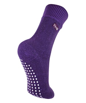 If you're looking for a slipper sock that's going to keep your little one's feet nice and cosy, look no further than THMO Kids Thermal Slipper Socks. The perfect pair to keep them warm while playing indoors. These socks have a stretchy comfort top that moulds to their leg to reduce constriction rings and tightness, which allows for regular circulation. As well as all day comfort, these socks feature a cushioned foot bed providing feet with an extra layer of support. They have been double brushed on the inside to maximise warmth by trapping warm air and keeping it close to their feet and legs. This inner brushing also softens the inside of the sock making it a great choice for keeping them warmer for longer. These anti slip grippers have been designed to prevent you from slipping on surfaces such as hard wooden floors or kitchen tiles. The dotted design on the foot of the sock is simple but effective. Perfect when they’re playing around the house. These Children’s Thermal Socks come in 4 colour options: Black, Navy, Fuchsia, Purple. They also come in 3 kids size options: 9-12 UK, 12-3 UK and 4-5.5 UK, The THMO badge is also heat transferred onto the side of the socks. These socks come in 4 different colours and are made from 93% Acrylic, 6% Polyamide, 1% Elastane. They are available in 3 Children’s sizes 9-12 UK(27-30 EUR 10-1 US), 12-3 UK (30-36 EUR, 13-4 US) and 4-5.5 UK(37-38.5 EUR, 5-6.5 US). They are machine washable at 40.