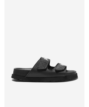 Introducing the Kids Logo Sandals in Black, an essential for your child's wardrobe from the renowned Spanish designer Palm Angels. Perfectly suitable for both genders and fit for all your summer fun. Check out the key attributes making this footwear exceptional:  Crafted in Spain: Manufactured meticulously with the highest quality assurance for durability and long-lasting wear. Stylish Logo Design: The signature Palm Angels design not only gives it a trendy touch but makes it an absolute statement piece. Comfort Personified: Made from premium materials, these sandals promise utmost comfort for your child's everyday adventures. Freshen up your child's footwear collection with our Kids Logo Sandals in Black from Palm Angels. Shop now and let your little one stride in style!