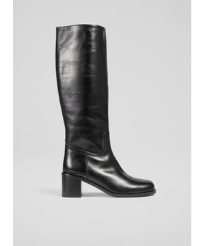 Imagine striding through cobblestone streets with an air of effortless elegance. The Claude knee boots, crafted from black Italian calf leather, feature a stylish block heel and a sophisticated rounded square toe. Perfectly versatile, pair them with tailored trousers for a smart look or with a flowing midi skirt for a casual charm.