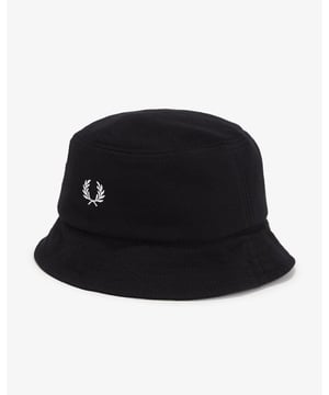 A cotton pique bucket hat with a simple embroidered laurel wreath logo.
100% Cotton
HW6730