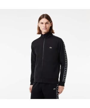 Color combinations and graphics for a Lacoste dynamic and creative identity The Joggers tracksuits : Comfort shape Classic fit  natural ease on body with comfortable sleeves Full zipped sweatshirt in brushed fleece 4cm Lacoste wording and crocodile tape along sleeves 3cm green crocodile sewn on at chest.
