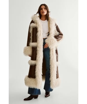 Luxurious faux fur trim adorning hood, cuffs, and hem
        Long, dramatic silhouette for a bold statement
        Hooded design for added warmth and style
        Contrasting textures between smooth outer fabric and plush trim
        Versatile duffle coat style with aviator-inspired details
    
    Make a striking entrance with this eye-catching Premium Duffle Hooded Aviator Coat from NastyGal. This coat combines the classic duffle style with aviator-inspired elements, creating a unique and fashionable piece. The long, sweeping silhouette is perfect for those chilly days when you want to wrap up in style. Pair it with your favourite jeans and ankle boots for a casual yet chic look, or throw it over a midi dress and heeled boots for a more dressed-up ensemble. Ideal for casual outings, family gatherings, or even a night out with friends, this coat is sure to turn heads wherever you go. The plush faux fur trim adds a touch of luxury, while the hooded design offers both practicality and an extra style element. This NastyGal coat is a versatile addition to your wardrobe that will keep you looking fabulous throughout the colder months.