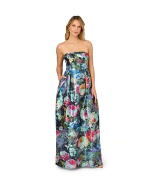 Luxurious details elevate this metallic floral ball gown. This evening gown features a fitted bodice with boning for structure, a strapless straight neckline with fold over detail, and a full ball skirt. Designed from floral print metallic jacquard fabric imported from France, this ball gown has crinoline under the pleated skirt for added volume. A hidden zipper closure at the centre back and pockets within the skirt completes this strapless gown. A perfect look for a black-tie event or formal wedding, this floral gown looks great when paired with nude heels and a statement-making clutch.