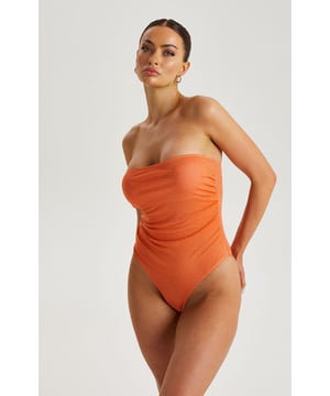 Model is 5'6 and wears a size 8.Sparkly Texture. Bandeau. Fully lined. Shop our new in Orange Sparkly Bandeau Swimsuit to stand out this summer.This swimsuit features a glittery orange lurex finish with a bandeau design.