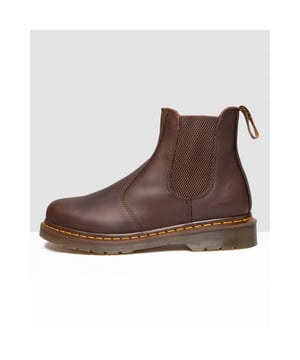 The Dr. Martens 2976 Chelsea boot is a slick, uncompromisingly fashion-forward look for both men and women. Made with naturally distressed Crazy Horse leather, this easy-on, easy-off boot serves up a sure fit with its signature elastic ankle gusset.The 2976 is the rugged Docs take on the classic Chelsea boot. Manufactured since the 70s.Crazy Horse is a heavyweight leather with a tough, textured appearance — designed to look worn in from the first stepGoodyear-welted lines are heat-sealed at 700°C and reinforced with DM's signature welt stitch