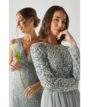 If a showstopping bridesmaid gown is what you're looking for, you're in the right place. Featuring a bodice swathed in dazzling sequins that glimmer in an art-deco pattern under the light, this design is finished by a delicate tulle skirt, adding to the sophisticated, old-time glamour aesthetic. Made from embellished sequins: exquisitely ornated with hand-sewn beads, this luxurious fabrication has a heavyweight feel, encasing your figure for a sculptural silhouette. Every unique pattern is created exclusively in-house by a team of artists. Level of stretch: none. This dress fastens with a rear concealed zip.This style is part of the Coast Honoured Collection, a dedicated range of never out-of-stock, bridesmaid dresses guaranteed to favour every member of your bridal party. Available in a selection of bestselling colour palettes, perfect for mix-and-match groups.