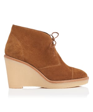 New season styling welcomes a fresh take on textures and tones and Madi&rsquo;s tobacco suede boots are a stylish case in point. Taking inspiration from the classic desert boot, this ankle-length design is given towering height with a rubber platform and wedge heel, immediately lending itself to relaxed tailoring silhouettes and wide-legged flares. Fastened with a delicate bow at the front and featuring a flattering almond-shaped toe, wear these with raw-hemmed denim and a cosy cable knit for relaxed weekend elegance.
