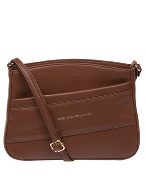 The 'Helena' cross body bag from the Pure Luxuries Marylebone collection is handcrafted from high-quality, genuine Nappa leather with a natural super-soft touch. The zip-over top opens to reveal a 100% cotton-lined interior. The spacious compartment features two slip pockets to help maintain an organised bag. A zipped pocket on the front of the bag provides on-the-go storage. Features gold-coloured metal fittings and zips alongside the adjustable slim leather strap, with a maximum drop length of 65cm. The Pure Luxuries logo is embossed in gold foil for a beautifully simple finishing touch.