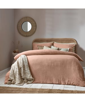 Inspired by timeless classic fabrics, the Lark duvet cover set is made from ultra-soft double-layer muslin cotton fabric. Available in a range of pastel tones, this bedding is complete with a wooden button closure. The cosy crinkle texture is perfect for bringing a relaxed, stylish feel to your bedroom. Cool and breathable in the summer months and snuggly and warm in the winter, muslin is used on both sides for an understated yet modern look. This product is certified by OEKO-TEX®, showing it has been sustainably made.