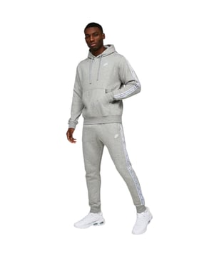 Nike Club Tape GX Suit in Grey Plush 2-piece suit crafted from high-quality, sustainable and breathable materials. Great for training and active leisure. The top half is an overhead hoodie complete with adjustable drawstring hood, rib cuffs and hem, contrast sleeve branding tape, front kangaroo pouch pocket and Nike logo to left chest. The matching bottoms boast an elasticated adjustable drawstring waistband, rib cuffs, open hand pockets and the same matching contrast side tape