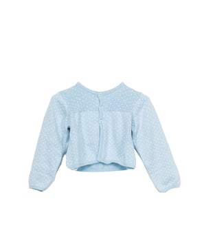 Tricot gebreid jack.
 Ronde hals.
 Knoopsluiting aan de voorkant.
 Contrasterende stippen.
 Samenstelling: 75% Katoen, 20% Polyamide, 5% Wol
 Onderhoud:
- Maximaal wassen op 30ºC.
 - Strijken op gemiddelde temperatuur, max. 110ºC.
 - Droger is niet toegestaan.
 - Geen bleekmiddel gebruiken.
 - Kan niet chemisch gereinigd worden.
