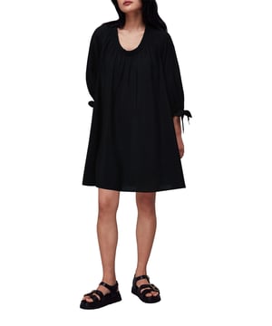 Embrace effortless style with the Lydia Dress, a black tunic with an elegant gathered trapeze silhouette. This day-to-evening piece features a flattering round neck and chic 3/4 sleeves with tie details. Crafted from a soft blend including eco-friendly viscose, it ensures both comfort and sustainability. Perfect for casual outings, this plain, versatile dress promises to be a staple in any wardrobe.