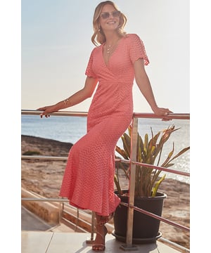 Flattering &amp; feel-good - our favourite kind of dress
Figure-enhancing faux wrap fit
Crafted from stunning chevron lace
Nipped-in waist falls to a swishy fishtail hem
Framed by beautiful scalloped sleeves
Coral shade looks gorgeous with silver and gold