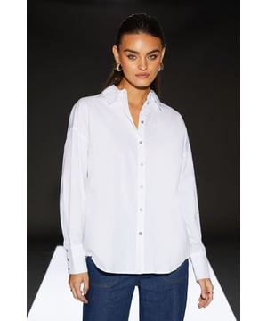 Striking cross-back design for a modern twist
        Crisp cotton poplin fabric for a polished look
        Collared neckline adds a touch of sophistication
        Regular fit ensures comfort and versatility
        Long sleeves with button cuffs for adjustable wear
    
    This poplin cross-back shirt from the RUNWAY 1.8.1.8 collection is a contemporary take on a classic staple. The unique cross-back detail adds intrigue to your ensemble, perfect for those who appreciate innovative design. Style this versatile piece with wide-leg trousers and trainers for a chic daytime look, or pair it with your favourite denim for a more casual vibe. The regular fit allows for easy layering, making it ideal for family gatherings or casual outings. For a trendy twist, leave a few buttons undone and knot the front for a cropped effect. This shirt is a testament to how a simple white shirt can be reimagined to create a standout piece in your wardrobe, suitable for various casual events where you want to make a subtle yet stylish statement.