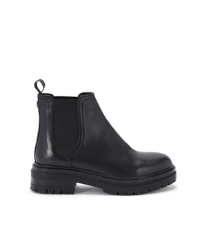 The Kurt Geiger Tasha boot features a smooth black leather upper. The ankle features two elasticated panels for slip on comfort. There is a small KG Kurt Geiger pull tab as well as gunmetal KG stud a the back of the ankle.