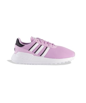 Junior adidas Originals LA Trainer Lite Trainers in bliss lilac - footwear white - core black.When it comes to shoes for kids  comfort is the name of the game. Even better if they're stylish too  and this pair from adidas handles both with ease. The EVA midsole and outsole are lightweight and flexible  and the OrthoLite® sockliner adds extra comfort. Signature 3-Stripes sport an outline detail on one side  and the unique tread adds a playful touch. Made with a series of recycled materials  this upper features at least 50% recycled content. This product represents just one of our solutions to help end plastic waste.- Kids' shoes with classic sport style  made in part with recycled materials.- Lace closure.- Mesh upper.- OrthoLite® sockliner.- 3-Stripes to sides.- EVA midsole and outsole.- Upper contains a minimum of 50% recycled content.- Textile upper  Textile lining  Synthetic sole.- Ref: GX1906
