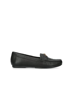 The Kurt Geiger Greenwich Moccasin slip-on loafer features a black leather upper with overstitch quilt detail on the toe. There is antiqued brass branding on the front alongside micro eagle head.