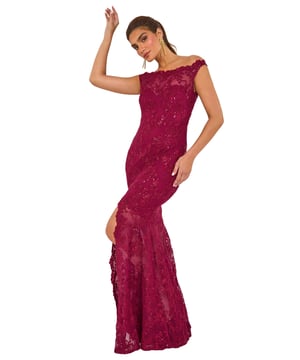 Lace Scallop Edge Front Split Maxi Dress from Roman. Get ready to make a statement in our stunning lace maxi dress. The feminine bardot neckline is adorned with delicate scalloped lace details, adding a touch of elegance to the look. Crafted from a stretch woven fabric, this bodycon dress hugs your shape beautifully and finishes at a flattering maxi length with a mermaid edge and front split for added drama. Pair with heels and a bolero for an unforgettable look!