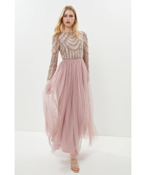 If a showstopping bridesmaid gown is what you're looking for, you're in the right place. Featuring a bodice swathed in dazzling sequins that glimmer in an art-deco pattern under the light, this design is finished by a delicate tulle skirt, adding to the sophisticated, old-time glamour aesthetic. Made from embellished sequins: exquisitely ornated with hand-sewn beads, this luxurious fabrication has a heavyweight feel, encasing your figure for a sculptural silhouette. Every unique pattern is created exclusively in-house by a team of artists. Level of stretch: none. This dress fastens with a rear concealed zip.This style is part of the Coast Honoured Collection, a dedicated range of never out-of-stock, bridesmaid dresses guaranteed to favour every member of your bridal party. Available in a selection of bestselling colour palettes, perfect for mix-and-match groups.