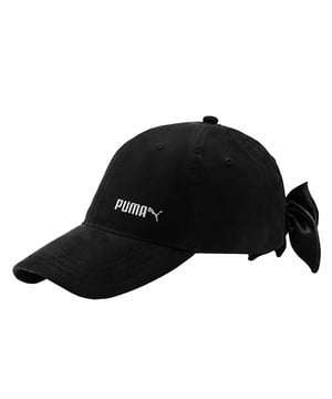 The Puma Plain Women's Bow Cap is a stylish and versatile hat designed for women who want to add a touch of fashion to their casual or athletic outfits. Puma is a well-known brand in sportswear and accessories, and this cap showcases their commitment to both style and functionality. Here are the key features and details of this cap:

Key Features:

 Bow Detail:  The standout feature of this cap is the bow detail at the back, which adds a unique and fashionable twist to the classic baseball cap design. The bow is typically made from the same material as the cap, creating a coordinated look.

 Adjustable Strap:  The cap usually features an adjustable strap or closure at the back, such as a hook-and-loop fastener or a buckle, allowing you to customize the fit to your head size and comfort.

 Embroidered Puma Logo:  Many Puma caps have the iconic Puma logo embroidered on the front, adding a branded and sporty touch to your outfit.

 Structured Crown:  The cap has a structured crown that maintains its shape, giving it a polished and classic appearance.

 Curved Brim:  The curved brim not only adds style but also provides shade and protection from the sun.

 Comfortable Fit:  Puma pays attention to comfort, and this cap is designed to feel comfortable and stay in place during various activities.

 Versatile Styling:  Whether you're wearing it to a workout, a casual outing, or as a fashion statement, this cap can be incorporated into a range of outfits and styles.

 Choice of Colors:  Puma often offers a variety of colors, allowing you to choose a cap that matches your personal style or coordinates with your other clothing.

 Durable Material:  Puma typically uses quality materials to ensure the cap's longevity, even with regular use.