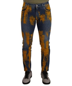 100% Authentieke Dolce & Gabbana skinny denim jeans  
Gemaakt van cotton stretch  
Slim fit  
Blauwe kleur met gele verf  
Rits- en knoopsluiting  
Logo details  
Gemaakt in Italië  
Materiaal: 98% Katoen 2% Elastaan