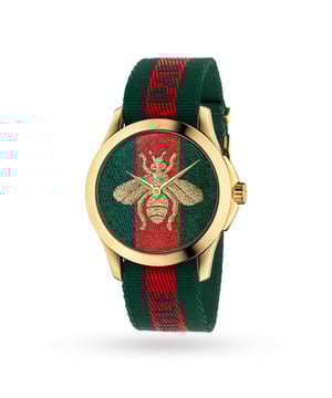 This expertly crafted unisex Gucci watch from the Timeless Fashion collection features an elegant 38mm PVD-plated case which showcases unique hour markers and a stunning red and green dial, all protected by Sapphire crystal glass.