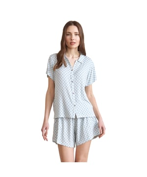 Pijamas de manga corta y pantalones cortos.  
Cuello con solapa.  
Camiseta con cierre de botones.  
Cintura elástica ajustable con cordón.  
Dos bolsillos abiertos a los lados.  
Costuras vistas en tono.  
Composición: 95% Modal, 5% Elastano  
Cuidado:  
Lavar a una temperatura máxima de 30º.  
Planchar a baja temperatura.  
No usar blanqueador.  
No usar secadora.  
No limpiar en seco.