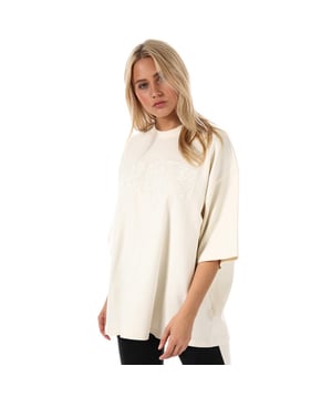 Women's Puma x Fenty Oversized Crew Neck T-Shirt in vanilla ice. From the Fenty Puma by Rihanna collection.  Soft cotton-blend construction. Ribbed crew neck. Drop shoulder. Short sleeves. Lace FENTY branding appliquéd at chest. Woven FENTY brand tab at left hem. Tonal back neck tape. Oversized fit. Measurement from shoulder to hem: 28in approximately. Shell: 91% Cotton  9% Nylon.  Rib: 96% Cotton  4% Elastane.  Hand wash. Ref: 574751-02. Measurements are intended for guidance only. This item is designed to be oversized.  Please order in your usual size and expect it to have exaggerated dimensions.