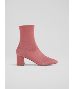 Step confidently into any occasion with the Harp block heel stretch ankle boots in a captivating rose hue. Made in Italy from sustainable stretch suede, these boots feature a stylish square toe and a sturdy block heel, perfect for smart or casual wear. Pair them effortlessly with tailored trousers or your favourite midi skirt.