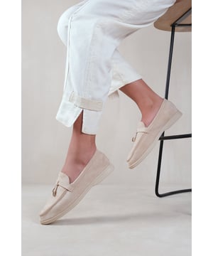 Stay effortlessly stylish and comfortable with our Women's Slider Loafers with Accessory detailing. These slip on sliders are the perfect addition to your wardrobe, offering both versatility and elegance. Crafted with a cushioned insole for all-day comfort and a rubber outsole for added traction, these slip on daily shoes will be your go-to for both casual and formal occasions.
Key Features:


Chic Design: The Suede material gives these slip ons a sophisticated look that will elevate any outfit, whether you're dressing up for a special occasion or keeping it casual or daily use for work.


Charm Detail: The charming accessory detail on the front adds a playful touch to these sliders, making them both fashionable and trendy.


Comfortable Fit: These loafers are designed with a comfortable fit in mind. With Shock-Absorbing Memory Foam slip them on and off effortlessly and enjoy a relaxed feel that lasts all day.


Durable Construction: Crafted with high-quality materials of Breathable &amp; Odor Resistant Foam. Constructed with longevity and comfort in mind, these loafers are designed to deliver both quality and luxury.


Versatile Style: These flat dolly sliders can be easily paired with a variety of outfits. From jeans and a t-shirt to smart office attire blazer and trousers, they effortlessly enhance any ensemble.


Perfect for Any Occasion: Whether you're headed to the office, a brunch date, or a night out with friends, these versatile sliders are suitable for any occasion, adding a touch of elegance to your look.


Specifications:

Material: Faux Suede
Colour:  Beige
Size Options: Available in multiple sizes
Closure: Slip-on
Sole: Rubber sole for comfort and traction

Invest in our loafer sliders and experience the perfect blend of style, comfort, and durability. Stay fabulous and make a fashion statement with every step you take.
Where's That From crafts footwear with the utmost care with YOU in mind. Our in-house unique designs offer the latest trends with supreme luxury comfort and unparalleled quality.