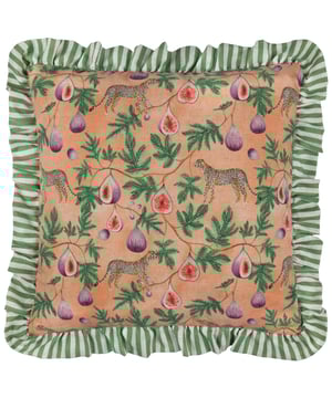 The Okara Leopard And Fig Printed Cushion encapsulates the perfect blend of modern design and nature-inspired artistry. Its hand-painted design brings a vibrant interpretation of the jungle’s charm, with painterly foliage, figs, and leopards exuding character and intrigue. The bold, textured print is framed elegantly by a striped double ruffle trim, adding a sense of dynamic contrast and sophistication. Designed for those who cherish pattern and the natural world, this cushion offers a statement piece that elevates both relaxed and maximalist interiors, seamlessly infusing contemporary spaces with an exotic yet refined aesthetic.