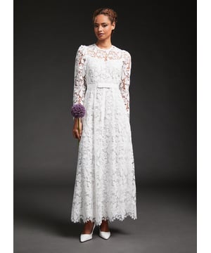 A wedding dress with a feminine, Fifties' feel, our Lola bridal dress is in our first-ever Bridal Collection. Crafted from a classic floral lace in off-white, it has a round neck, delicate puff shoulders, long sleeves, a slip layer, a nipped waist with a pretty grosgrain ribbon and a full skirt falling to just above the ankle. Every LK Bennett wedding dress arrives carefully-packaged with its own garment bag and white satin hanger, to keep it  perfectly pristine for the big day.
