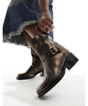 Shoes by Bronx Reboot in progress Pull-on style Buckle details Round toe Flat sole Mid block heelSold By: Asos