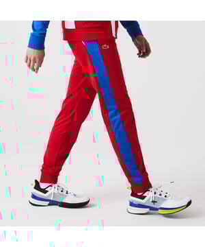 Men's Lacoste SPORT Run-Resistant Tennis Trackpants.- Regular fit, natural ease: The perfect fit for workouts.- Drawstring waist: Customised comfort and fit.- Contrast print on side: The iconic Lacoste colour-block.- Rigid crocodile sewn onto front: Quintessentially Lacoste.- Recycled polyester run-resistant piqué: Lightweight. Environmentally friendly. Material: 100% Polyester. Ref: XH9427W50.