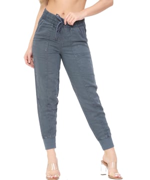 MYT Dames Taps toelopende broek van hoge kwaliteit met koord. - Binnenbeenlengte Kort is 26 inch, Normaal is 27 inch, Lang is 28 inch. - - .   Taps toelopende pasvorm met een flatterende enkellengte en omgeslagen pijpen voor een gemakkelijke Jogger-stijl. - - .      Comfortabele, hoog uitgesneden elastische taille met een verstelbaar trekkoord. - - .  Twee handige zijzakken en twee zakken op de achterkant voor een trendy utility vibe. - - .   De stof is geverfd voor een authentieke look en bevat zacht, ademend katoen voor een luxe afwerking. - Ideaal voor de zomer, casual, lounge en vakanties.