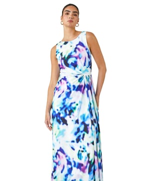 Abstract Print Twist Drape Ruched Maxi Dress from Roman. Take your occasionwear to the next level with this vibrant abstract print maxi dress. Easy to pull on, overhead, this sleeveless style has a flattering twist drape detail at the waist and a timeless round neckline with a stunning v-back. This full length dress exudes evening glamour with its silky, stretch jersey body that skims your figure beautifully. Simply add heels and a statement fascinator for your next Wedding or day at the races!
