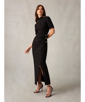 Co-founders' Notes

Elevate your wardrobe with our Black Ribbed Button Detail Split Front Dress, a true fashion statement. This midi dress is crafted from luxurious knitted ribbed fabric, providing both style and comfort. The high neckline and draped detail skirt offer a fashion-forward edge, while the gold texture feature buttons add a touch of sophistication. Whether you're heading out during the day or for a night out, this versatile dress seamlessly transitions from casual to elegant, making it a must-have addition to your collection.
High neckline

Gold textured buttons
Draped detail skirt
Slim fit. Try your usual size

  

Fabric &amp; Care



Composition:  Main: 96% Polyester 4% Elastane 


Garment Care: Hand wash



Size &amp; Fit


Slim fit. Try your usual size

Length of dress: 135cm

Model is 170 cm/5'7" and is wearing a size 10