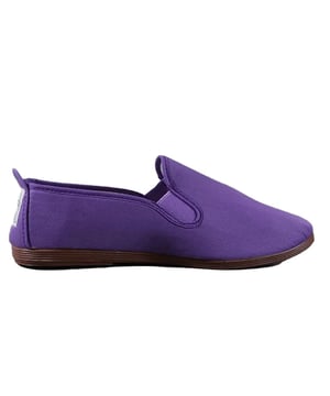 These plimsolls are designed to make a bold statement with their eye-catching purple hue and sleek silhouette. 

Crafted with meticulous attention to detail, these plimsolls feature a soft and breathable canvas upper that wraps around the foot, providing a snug and comfortable fit. The purple color exudes a sense of playfulness and adds a pop of color to any outfit. The slip-on design makes them convenient and easy to wear, perfect for those on the go.

The Flossy Morado Plimsolls showcase a minimalist yet stylish aesthetic. The clean lines and streamlined silhouette give them a modern and fashionable look that can effortlessly elevate any casual ensemble. Whether you're pairing them with jeans and a t-shirt or a summer dress, these plimsolls add a touch of personality and flair to your overall style.

Designed with comfort in mind, these plimsolls feature a cushioned insole that provides excellent support and comfort throughout the day. The flexible rubber outsole offers traction and durability, making them suitable for various activities and surfaces.

These plimsolls are not only stylish but also versatile. They can be worn for everyday outings, casual gatherings, or even as a comfortable option for light physical activities. Their lightweight construction and easy slip-on design make them a convenient choice for travel or when you need a quick and fashionable footwear option.

Embrace the vibrant and trendy style of the Flossy Morado Purple Women's Plimsolls. With their comfortable fit, versatile design, and eye-catching color, these plimsolls are the perfect choice for fashion-forward individuals who want to add a touch of playfulness and style to their everyday look.