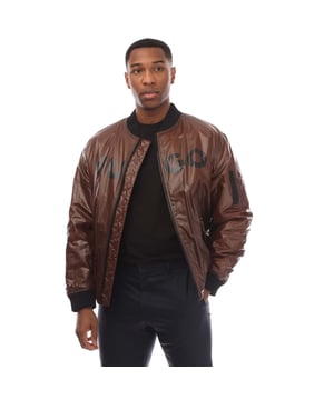 Mens HUGO Byler2431 Jacket in brown.- Ribbed bomber style collar.- Branded full front zip opening.- Two press stud entry pockets.- Zip entry pocket situated on the upper left sleeve.- Signature HUGO logo is printed on the chest.- All over padded design.- Ribbed cuffs and hem.- 100% Polyamide.- Ref: 50521233890