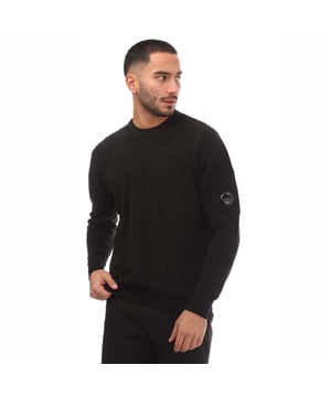 Mens C.P. Company Chenille Crewneck Sweatshirt in black.- Ribbed crew neck.- Ribbed cuffs and hem.- Sleeve patch-pocket with Company Lens detail.- Garment dyed.- Tonal stitching.- Regular fit.- 100% Cotton.- Ref: 17CMKN086A999
