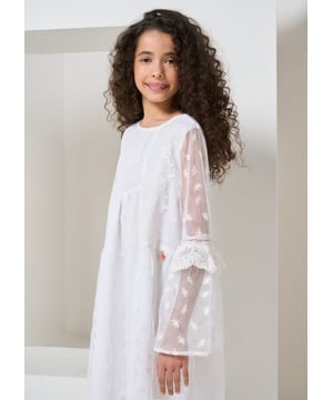 Bohemian beauty! This off white embroidered dress cut from diaphanous fabric has an A-line silhouette and exaggerated fluted sleeve. The bohemian reference continues with contrast embroidered detail on the yolk and sleeve and intricate lace trims. Exquisite!