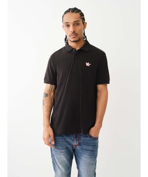 Pop that collar with the Buddha Patched Logo Polo Shirt. Crafted from soft cotton, this men’s polo features a basic collar. half-button placket, and short sleeves. Finished with a relaxed fit, ribbed trim, and a chest Buddha patch.