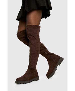 Knee-high boots with chunky silhouette
        Faux suede upper for a luxe look
        Flat heel (0-2cm) for all-day comfort
        Robust cleated sole for enhanced grip
        Side zip closure for easy on-and-off
    
    Make a bold statement with these eye-catching knee-high boots from Boohoo. The chunky silhouette and faux suede finish create a striking look that's perfect for the fashion-forward trendsetter. Designed with comfort in mind, the flat heel allows for effortless all-day wear, while the cleated sole provides excellent traction on various surfaces. Style these versatile boots with a flowy midi dress and oversized jumper for a chic autumn ensemble, or pair them with skinny jeans and a leather jacket for an edgy night-out look. Whether you're heading to a casual family gathering or a day out with friends, these boots will keep you on-trend and comfortable from dawn to dusk.