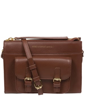 Handcrafted from Nappa leather, the 'Monica' cross body bag from the Pure Luxuries London Marylebone Collection elevates this classic design. A spacious main compartment is secured under a zip-over top which is lined with 100% cotton for a luxurious feel. Two slip pockets on the interior of the bag provide additional storage space - ideal for maintaining an organised accessory. Complementing the interior storage is a stylish pocket secured with a press-stud fastener made to look like a buckle reminscent of the classic satchel design. Gold-coloured metal fittings and zips adorn the bag alongside the slim and adjustable leather strap with a maximum drop length of 65cm. The Pure Luxuries logo is embossed in gold foil for a beautifully simple finishing touch.