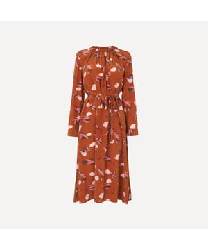 Embrace the hues of the new season with the beautiful rust-coloured Yadis dress. Featuring a whimsical, abstract-blossom print, the full length sweeps equally perfectly when paired with white trainers or heeled boots.